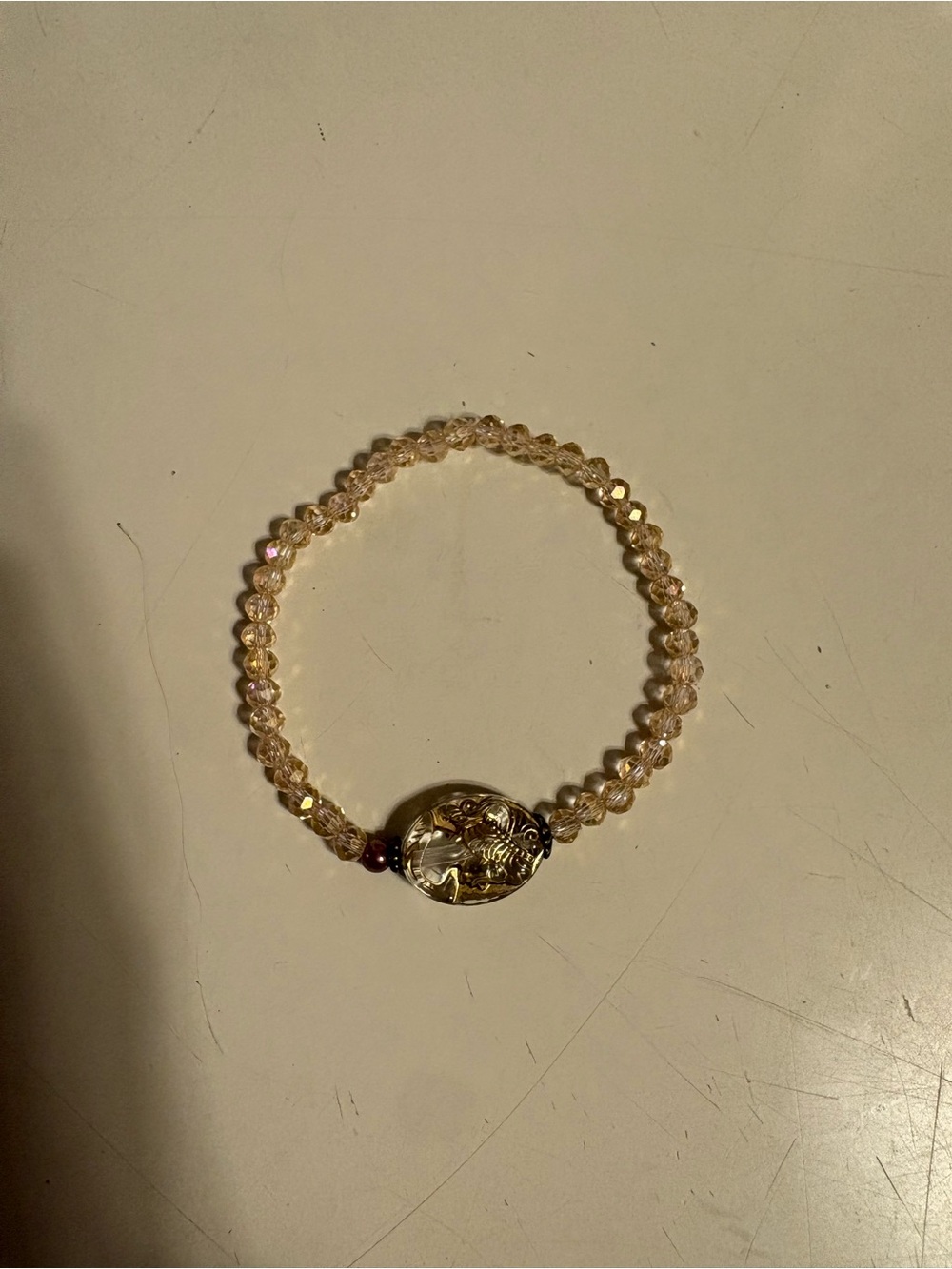 Faceted Champagne Bead Stretch Bracelet with Gold Oval Accent